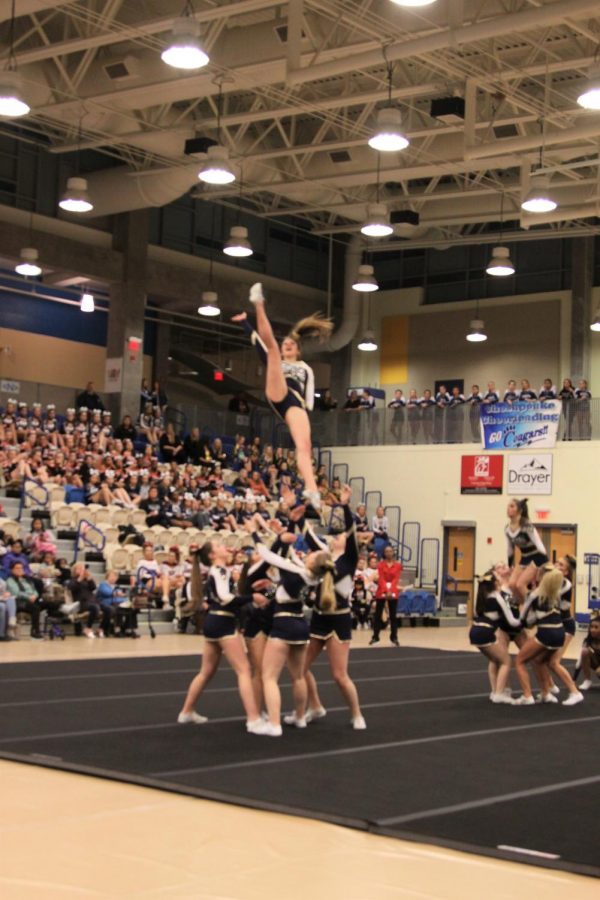 The cheer team doing a stunt at the state championship competition. The team placed tenth in their first ever appearance in states. We made it to states, thats all that matters, Ally Rohrs said. 