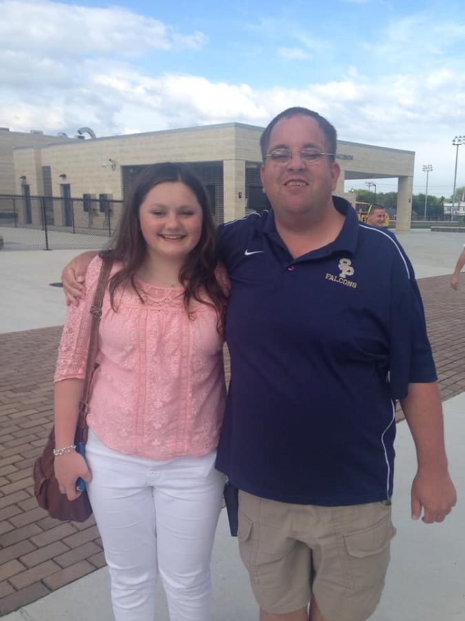 Formers SPHS students Macey Atcheson (Class of 2016) and Kenny Elgert (Class of 2005) stand outside of the athletic fields before a field hockey game in the fall.