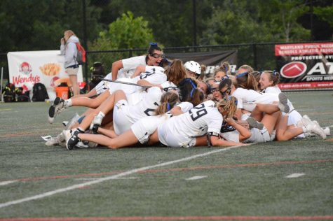 Girls lacrosse piles on top of each other after winning the 4A state title. The game was played at Paint Branch High School in Burtonsville, Maryland