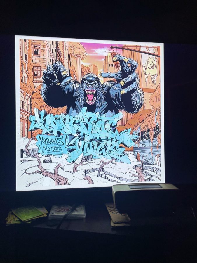 Kurious, mostly known for a couple features with MF DOOM, teams up with a mysterious artist named Ro Data to put together a 22 minute long EP with 8 separate songs. The tracklist includes songs that are all under 3 minutes, except for Seeing Ghosts, the outro track. The album cover depicts a massive monkey monster with “Koncrete Jungle” in heavily stylized writing. Photo by Noel Castillo

