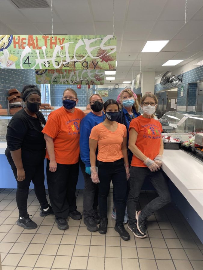 The lunch crew gathers in the lunch line after morning prep work. From left to right is Hohman in the dark orange, Dudley in the blue shirt and black mask, and Frazier in the light blue mask and pink bandana. “Basically, [our job] is to help out the manager in any way you can.” Dudley said. “Cook the food, prep it, lots of cleaning, doing whatever you can to make life easier for the manager. Photo by Noel Castillo
