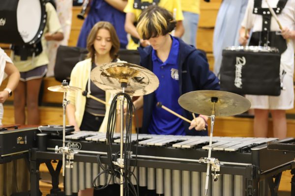 The last time Pep Rally was in the gym was Oct. 2023.  Caleb Rassofsky, 2024 graduate, plays the xylophone as the marching band welcomes students into the gymnasium. 