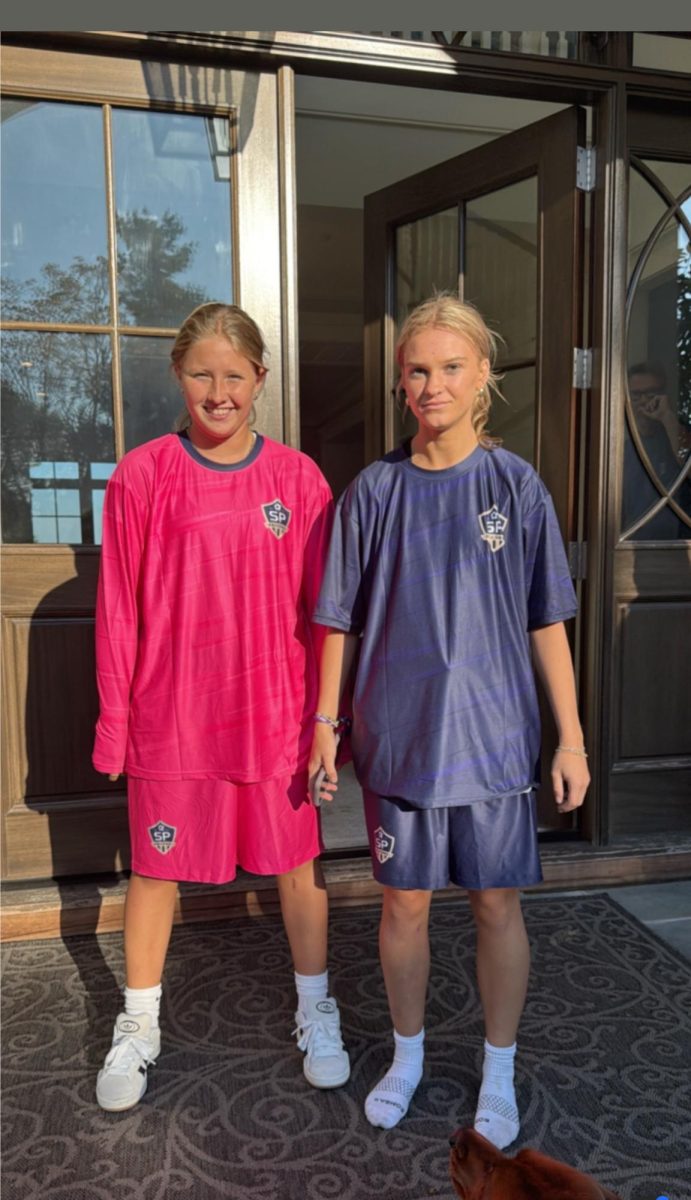 Sophomore Riley Buck and junior Ruby Bauer pose in new soccer uniforms outside of a team dinner. The team has since decided to return the jerseys to get them fixed to better suit a women’s team. As for the recent games, they have been sporting the Under Armour uniform from the previous three years. 

