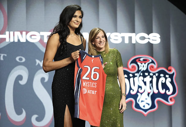  UCLA’s Lauren Betts poses with WNBA commissioner Cathy Engelbert and holds up a Washington Mystics jersey. Upcoming games for the Mystics include an away game against the Toronto Tempo on May 8, followed by the first home game on May 10 against New York Liberty. 
